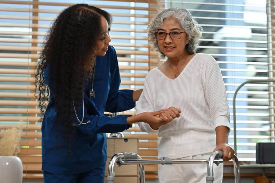 Physiotherapist assisting a stroke patient with walking rehabilitation